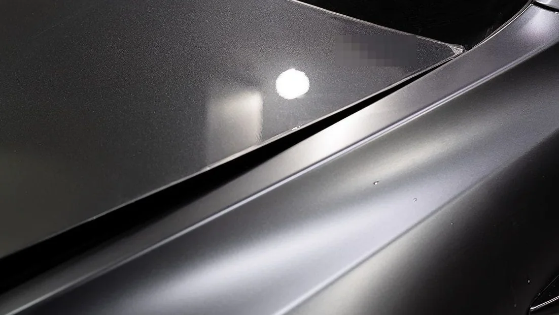 After: the same corner, the lamp reflected as one clean disc